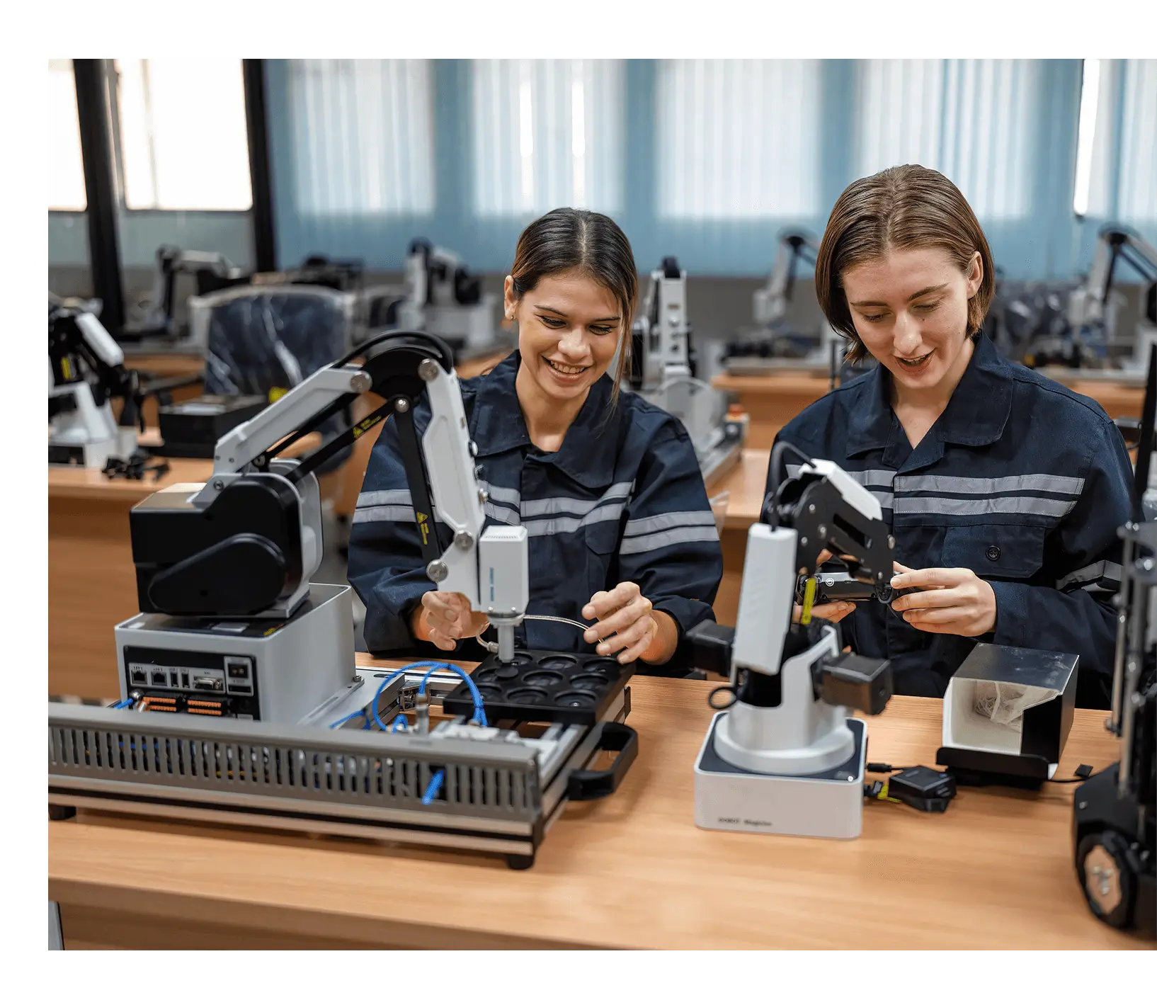 Two technicians assembling robotic arm components